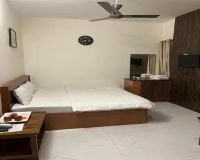 a bedroom with a bed and a clock on the wall at The Whistling Pine Woods in Varagampadi