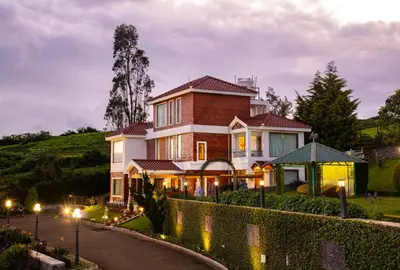 a house on a hill with a driveway at Western Valley Resorts Ooty in Ooty