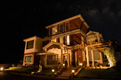 a house at night with lights in front of it at Western Valley Resorts Ooty in Ooty