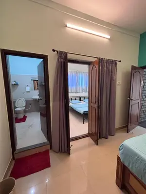 a bedroom with a mirror and a bed and a bathroom at 5 BHK Luxurious & Spacious Villa in Mysuru in Mysore