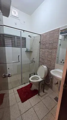 a bathroom with a shower and a toilet and a sink at 5 BHK Luxurious & Spacious Villa in Mysuru in Mysore