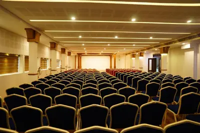 an empty room with chairs in a building at Sathya Inn Guruvayur in Trichūr