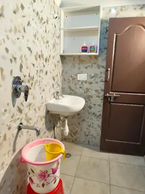 a small bathroom with a sink and a bucket at Namasvi 2Bedroom AC House in Narasimharaja Puram
