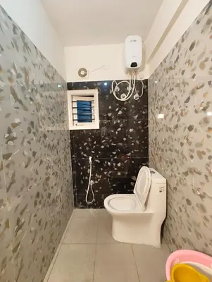 a bathroom with a toilet and a shower at Namasvi 2Bedroom AC House in Narasimharaja Puram