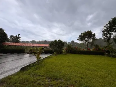 a garden with a bridge and a grass field at Malma view homestay in Kakkabe