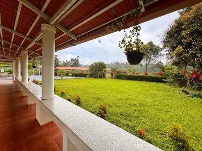 a porch of a house with a green yard at Malma view homestay in Kakkabe