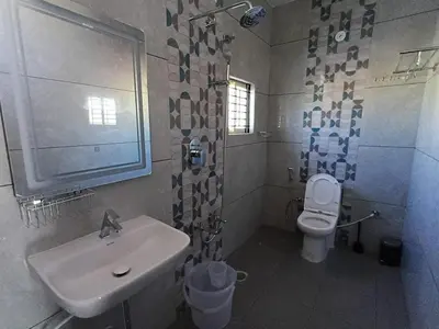 a bathroom with a sink and a toilet at Villa Vista in Mysore