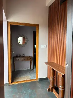 a hallway with a mirror and a table in a room at Villa Vista in Mysore
