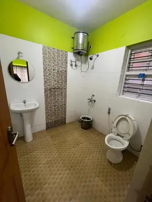 a bathroom with a toilet and a sink at Essar Cottage in Ooty