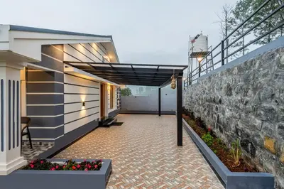a hallway of a house with a stone wall at Riverstone Haven in Kotagiri