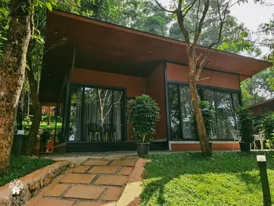 a house in the middle of a garden at Tree Valley Resort Wayanad in Meppādi