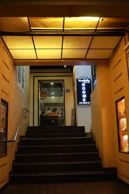 a set of stairs leading up to a restaurant at Vinayaka Tourist Home in Kozhikode