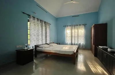 a bedroom with a bed in a blue room at Aquatica by bough'n villa in Kenichira