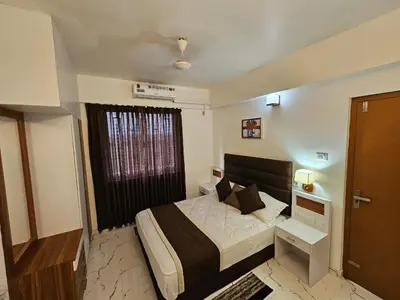 a small bedroom with a bed and a window at krishna paadham in Guruvāyūr