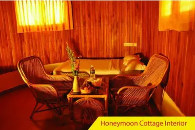 a room with two chairs and a table and a bed at Cybele Hill Resort in Kalpetta