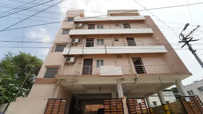 a building with a balcony on the side of it at Aangal residency in Coimbatore