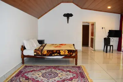 a bedroom with a bed and a rug on the floor at Brindavan Lake Resort in Munnar
