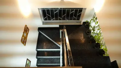 an escalator in a building with stairs and plants at The Moon Graceful Villa in Ketti