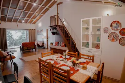 a dining room with a table and a staircase at Hope Horizon Luxury Villa By LexStays in Coonoor