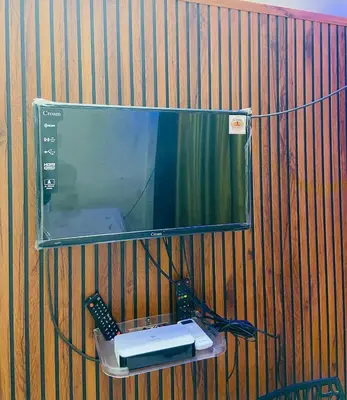 a mirror on a wall with a sink and a remote control at Flat in Guruvayur- Sooryamadhavam Apartments- Family only in Guruvāyūr