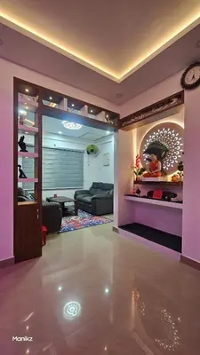 a living room with a couch and a large mirror at Kulipini Family Apartment in Irinjālakuda