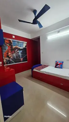 a bedroom with two beds and a ceiling fan at Kulipini Family Apartment in Irinjālakuda