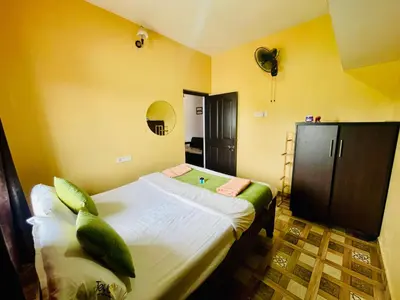 a bedroom with a large bed in a room at Teyt Castle - Ooty - Nilgiris in Ooty