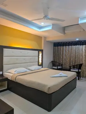 a bedroom with a large bed in a room at Hotel TriColors Ramnagar Gandhipuram in Coimbatore