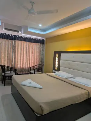 a bedroom with a large bed in a room at Hotel TriColors Ramnagar Gandhipuram in Coimbatore