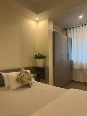 a bedroom with a bed with a plant on it at Crest By Irishighes in Perintalmanna