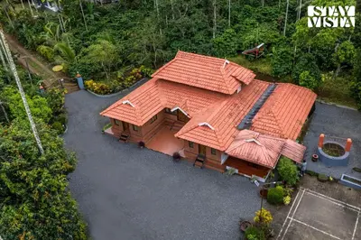 an overhead view of a house with an orange roof at StayVista at The River Mist with complimentary Breakfast & Bonfire in Wayanad