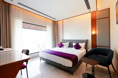a bedroom with a bed and a desk and a chair at celestia by thoppil in Kottakkal