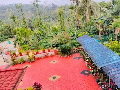 a garden with a red carpet and a bench at Cozy Coffee Estate Homestay Coorg Madikeri in Madikeri