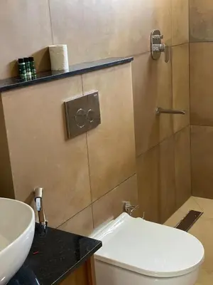 a bathroom with a toilet and a sink at Ozone The Misty Villa - Hill View in Coonoor