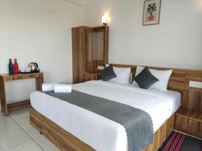 a bedroom with a large bed in a room at Nirvanica Retreat Wayanad in Padinjarathara