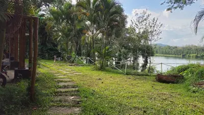 a stone path next to a body of water at Grace Backwater Villa Coorg in Suntikoppa