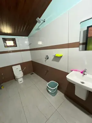 a bathroom with a sink and a toilet at Edakkal Hearth in Ambalavayal