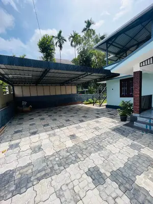 a patio in front of a building with a roof at Edakkal Hearth in Ambalavayal