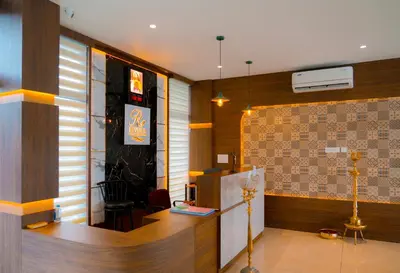 a lobby with a reception desk in a building at Rivera resort and wellness center in Kodanad