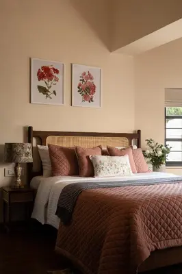 a bedroom with a large bed with pink pillows at amã Stays & Trails - Mount Pleasant, Coonoor in Coonoor