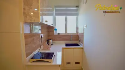 a small kitchen with a sink and a window at Padmalaya Homestay ! in Guruvāyūr