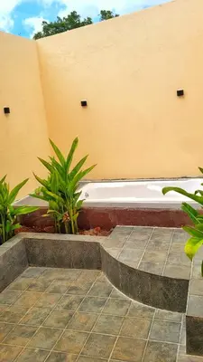a white bath tub sitting next to a building at Eden Garden Bandipur Tiger Reserve in Gundlupet