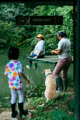 a group of people and a dog looking at water at Lolo's by Raho - Loft Stay in Coorg in Ammatti