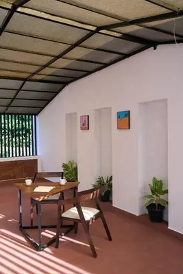 a dining room with a table and chairs at Nila by Raho - Secluded Villa with Estate View in Siddapur