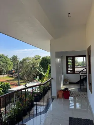 a balcony of a house with plants on it at Calm Serenity Homestay in Kozhikode