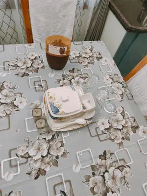 a table with flowers on it with a phone on it at Vani Vilas Luxury Villa in Mysore