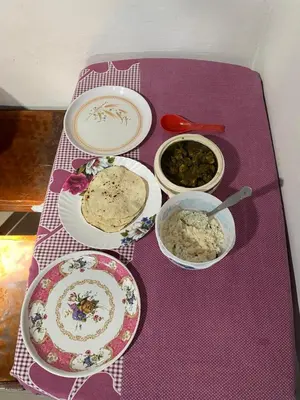 a purple table topped with plates and bowls of food at Nirvana Private Villa in Kushālnagar