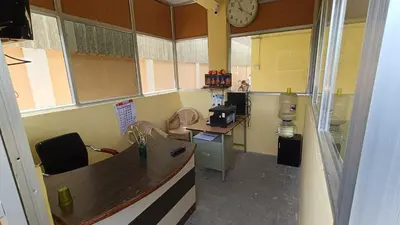 an office with a desk and a clock on the wall at GM nest in Coimbatore