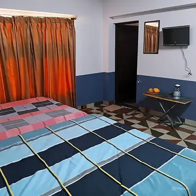a bedroom with a bed and a tiled floor at Varshini home stay in Kotagiri