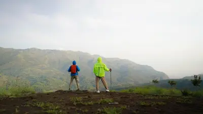 two people standing on the top of a mountain at Era Resort Slope Stay in Kodaikānāl